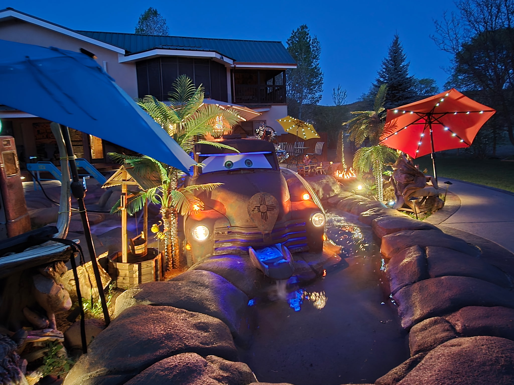 Vintage truck water feature lit up at night