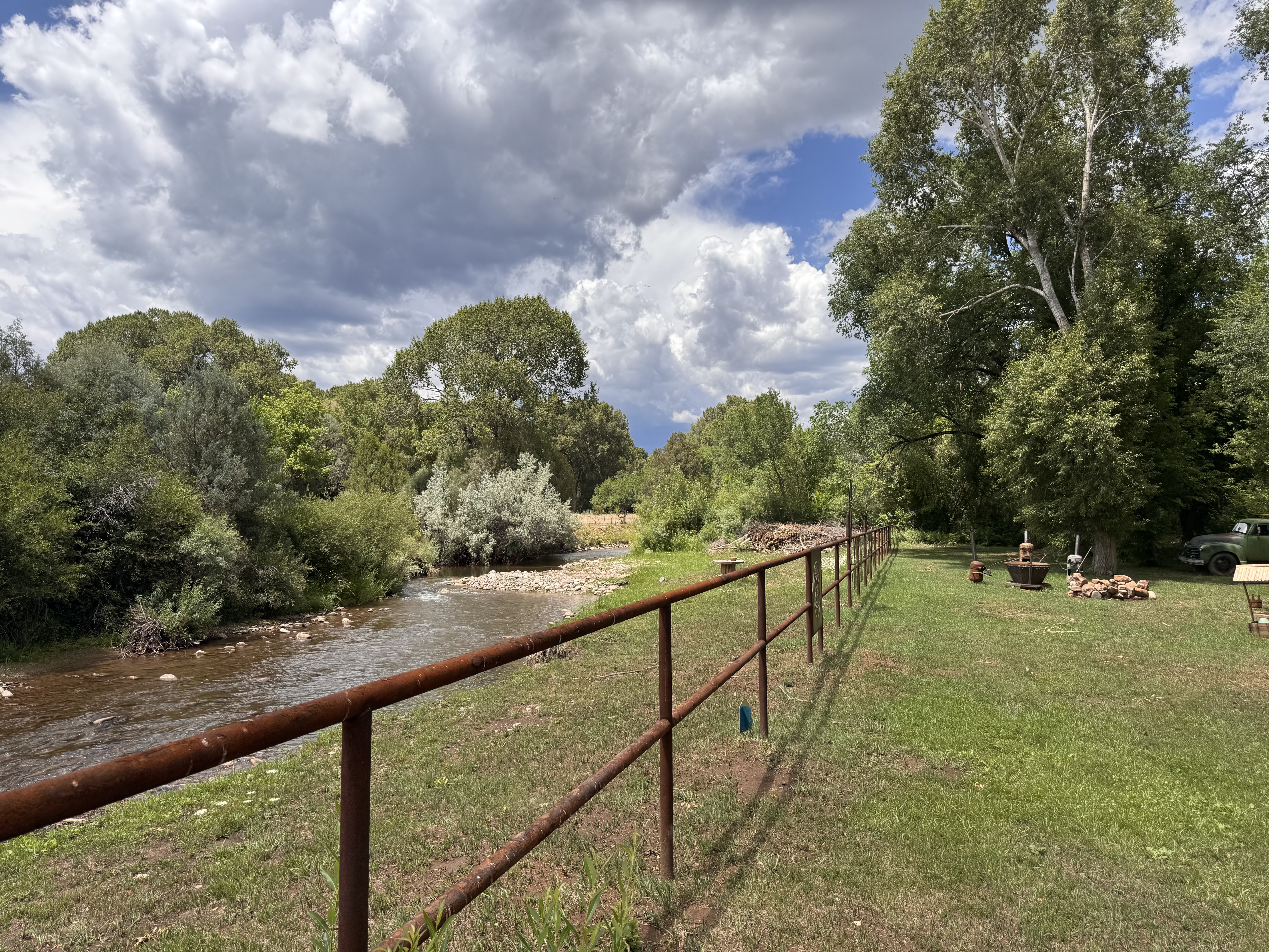 Fence line along the river with yard art