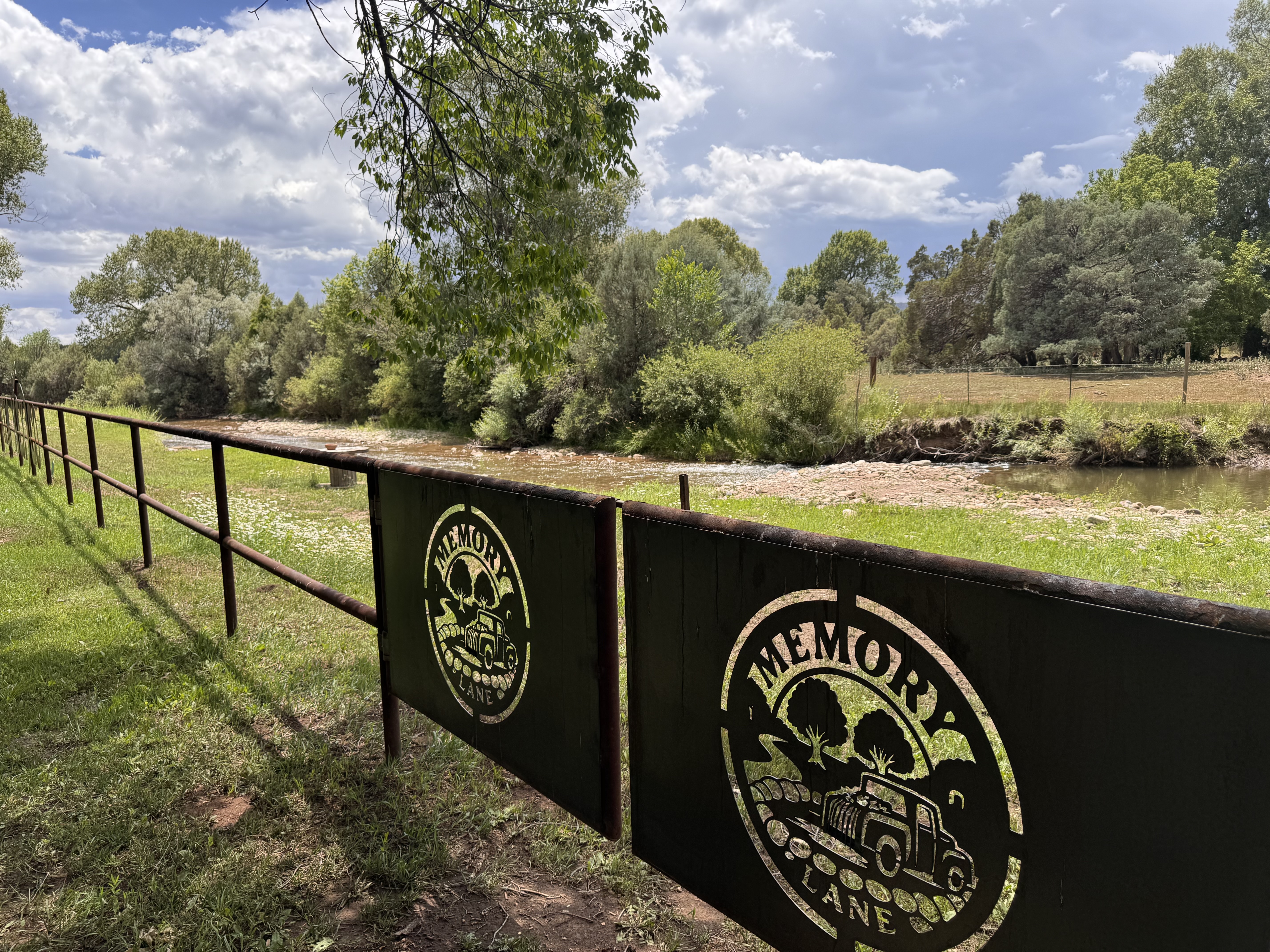 Memory Lane branded sign along the riverbank fence