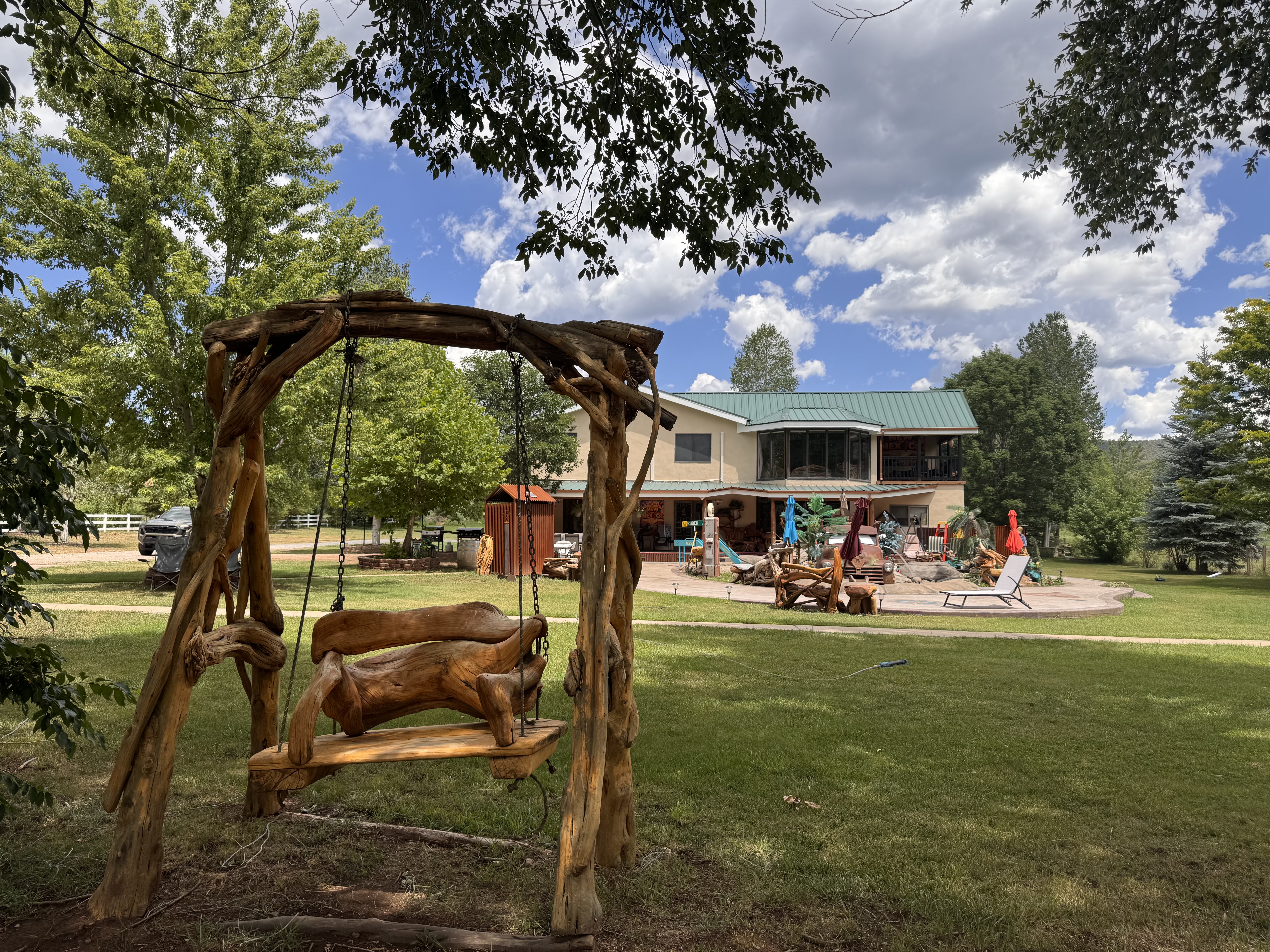 Handmade driftwood porch swing overlooking the main house